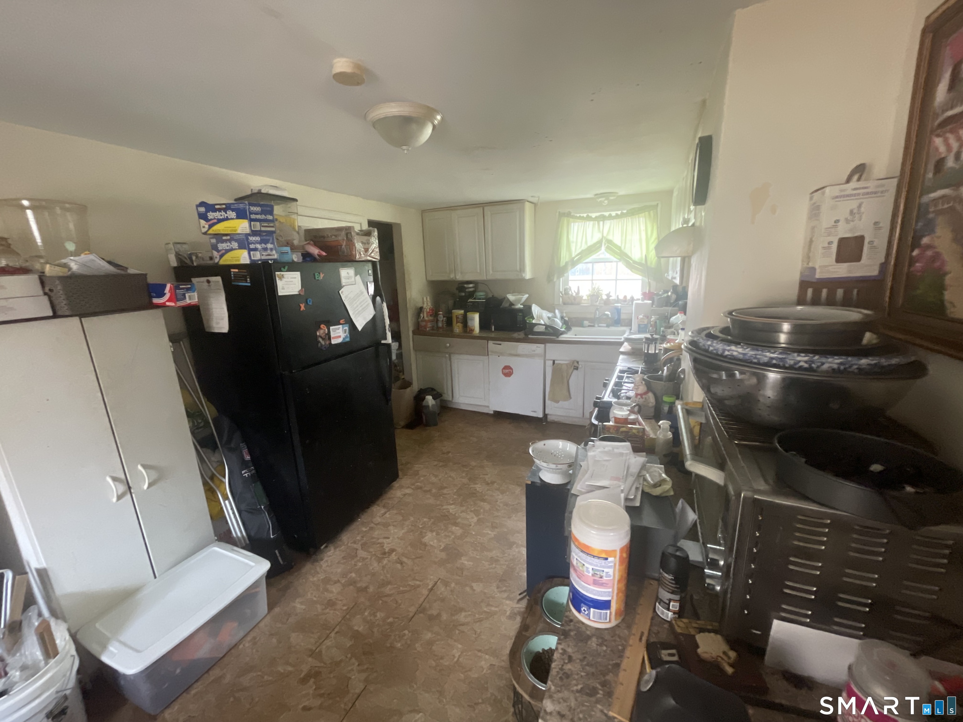 40 Grove Street Ansonia, CT 06401 - Photo 9 of 21 a room with water heater and wooden cabinets