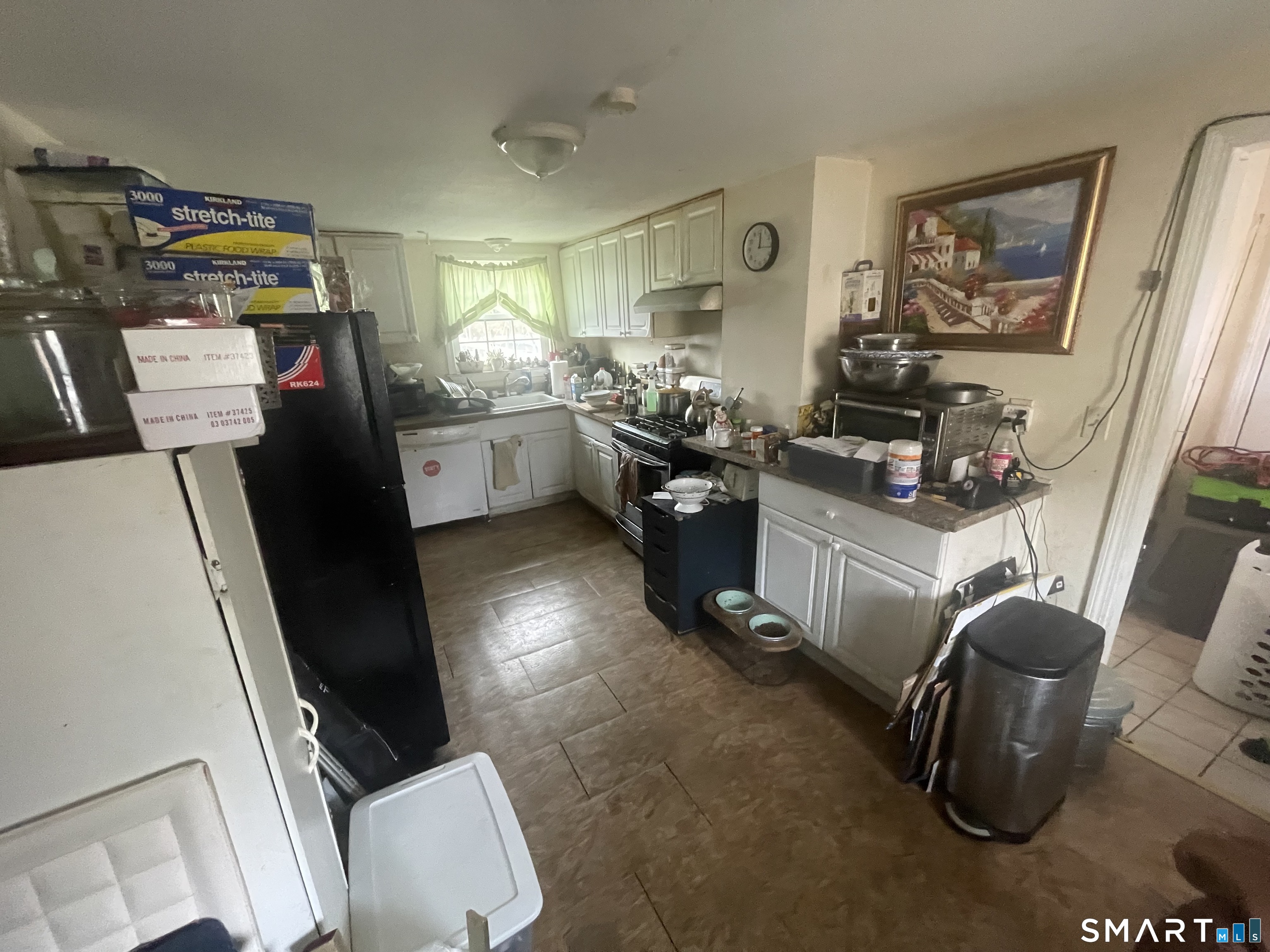 40 Grove Street Ansonia, CT 06401 - Photo 10 of 21 a kitchen with stainless steel appliances a sink a stove a refrigerator a couch and a window