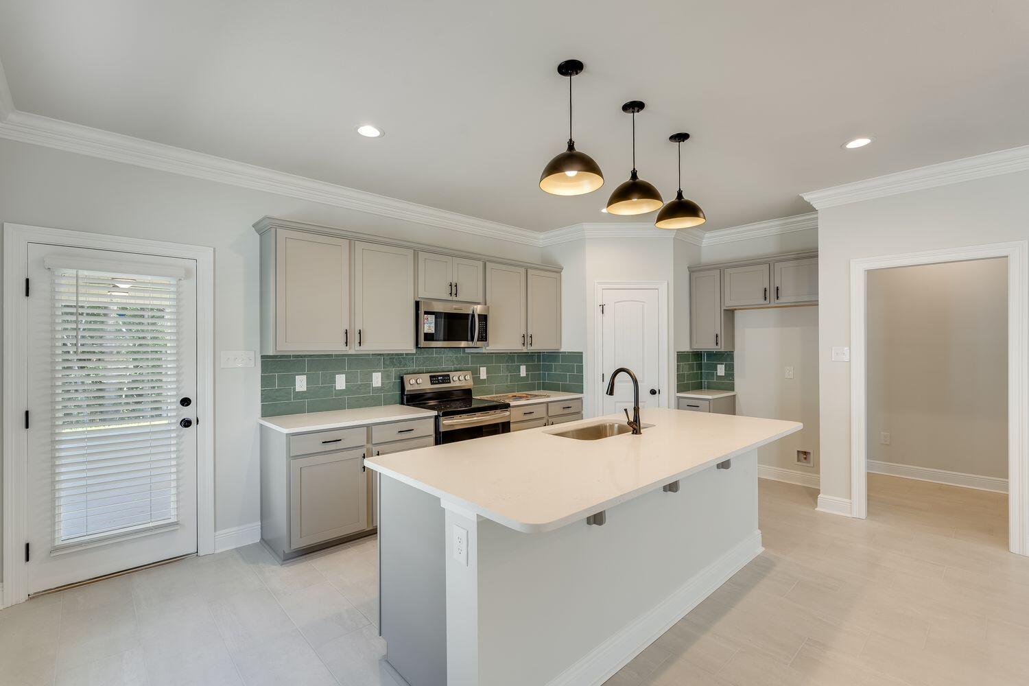 77 Eclipse Loop Freeport, FL 32439 - Photo 10 of 31 a kitchen with a sink a stove cabinets and refrigerator