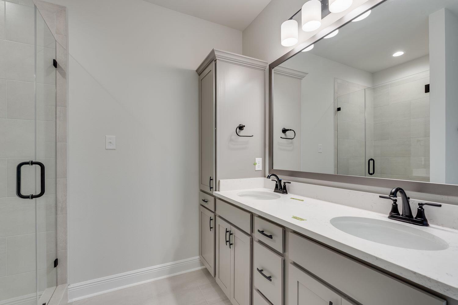77 Eclipse Loop Freeport, FL 32439 - Photo 16 of 31 a bathroom with a double vanity sink and mirror