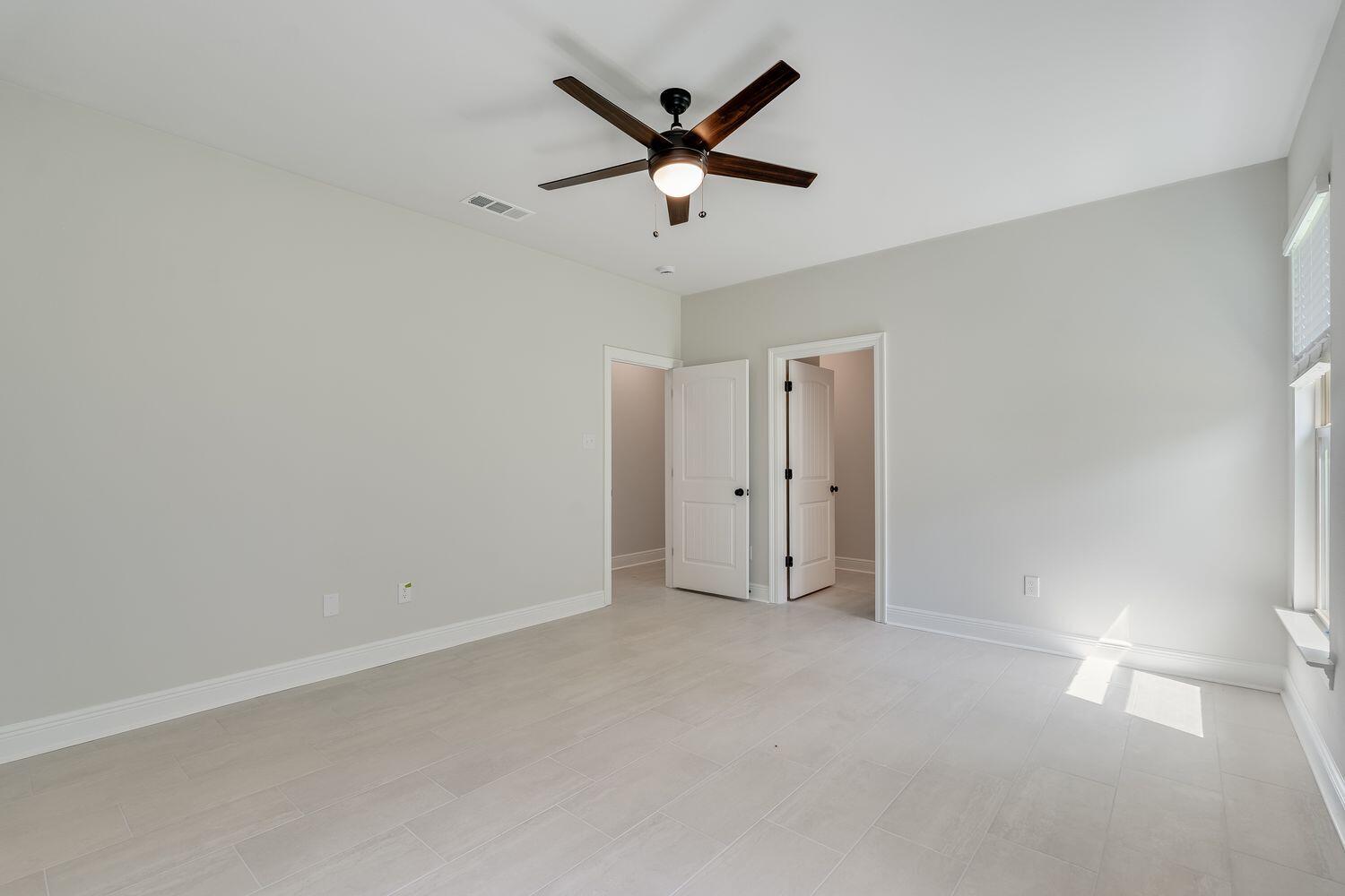 77 Eclipse Loop Freeport, FL 32439 - Photo 19 of 31 an empty room with closet and ceiling fan
