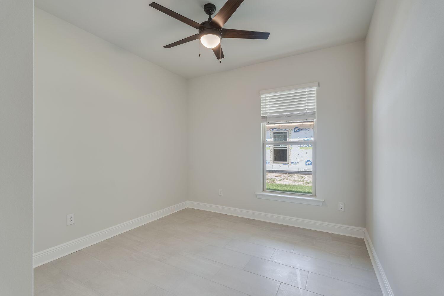77 Eclipse Loop Freeport, FL 32439 - Photo 20 of 31 an empty room with a window and ceiling fan