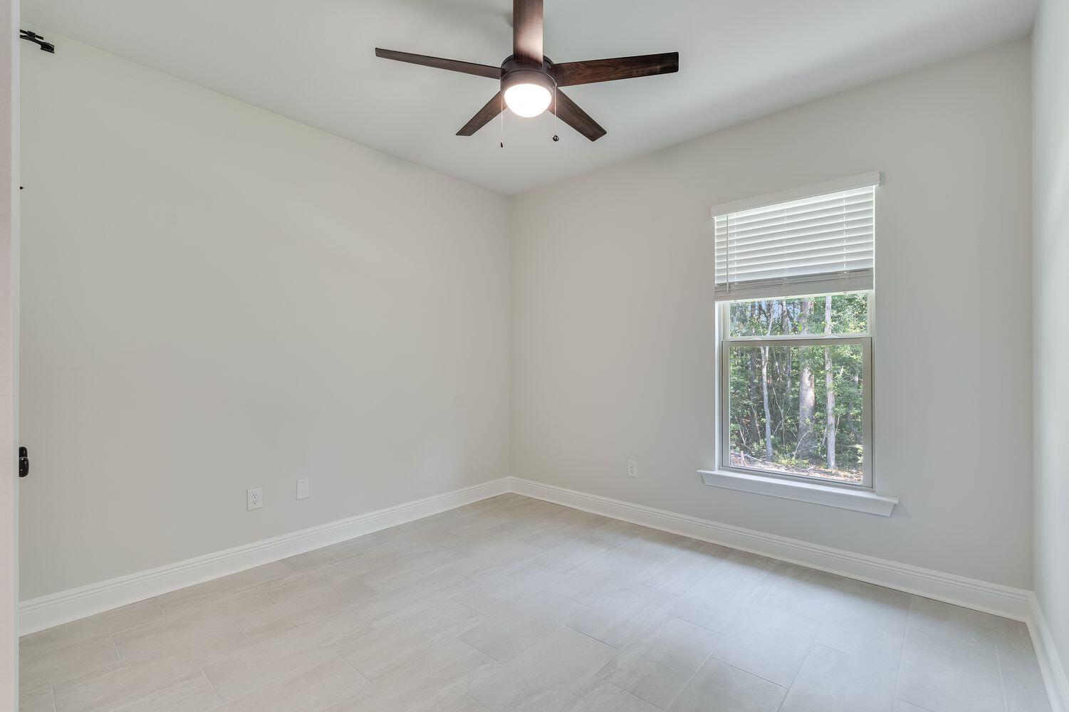 77 Eclipse Loop Freeport, FL 32439 - Photo 22 of 31 an empty room with a window and a fan