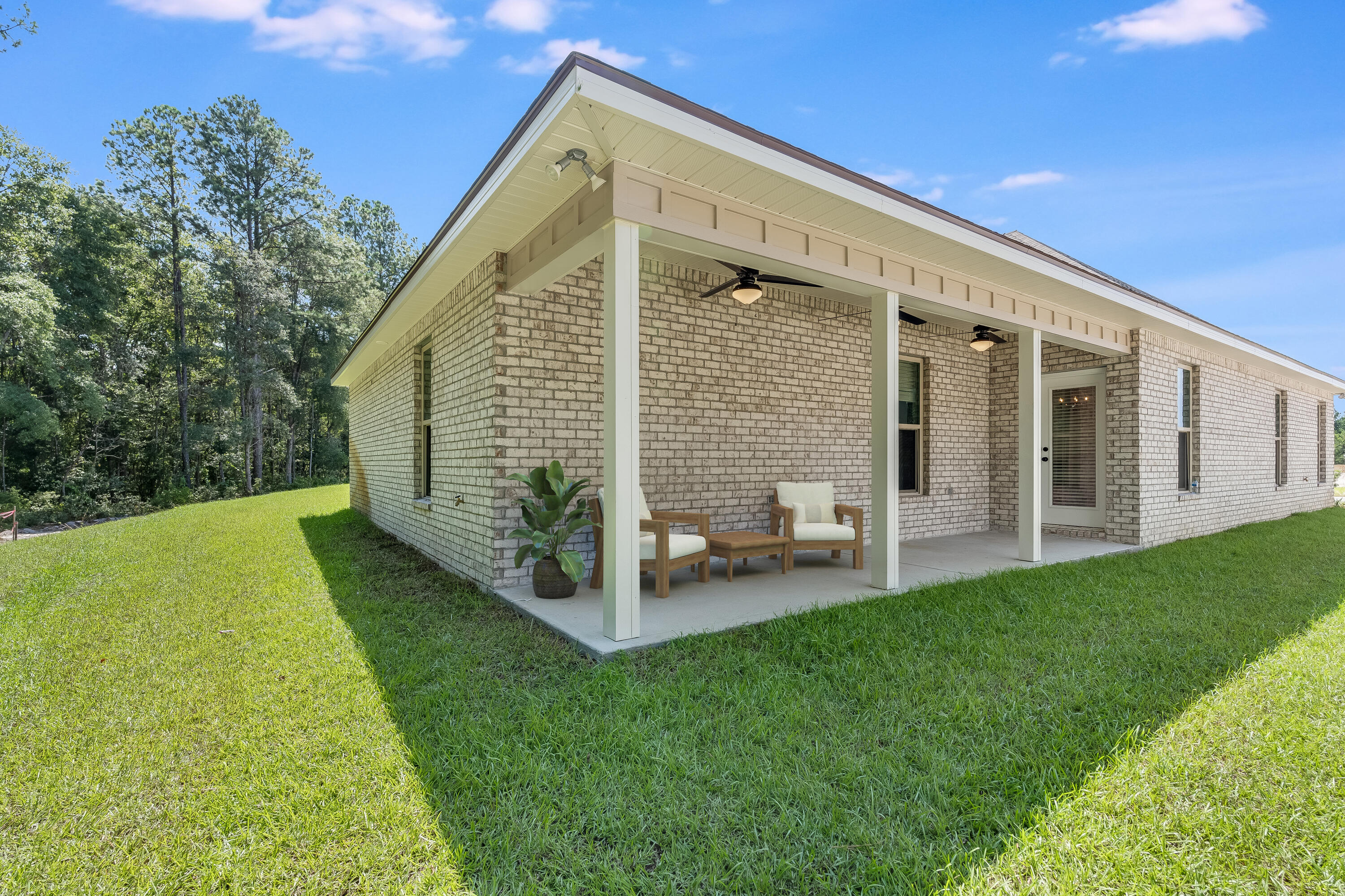 77 Eclipse Loop Freeport, FL 32439 - Photo 4 of 31 a view of a house with backyard porch and sitting area