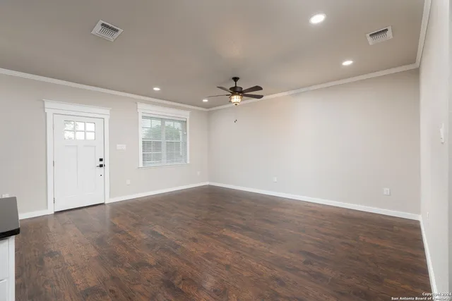 a view of an empty room with a ceiling fan