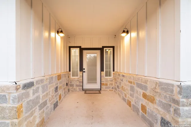 a view of a backyard with table and chairs and wooden fence
