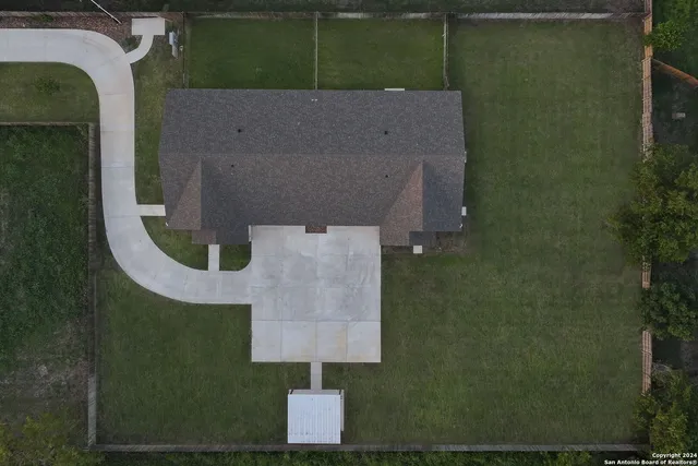an aerial view of a residential houses with outdoor space and river