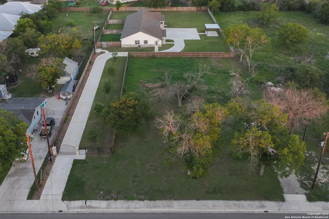an aerial view of house with yard