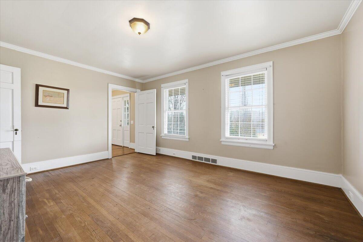 9419 Franklin Street Ferrum, VA 24088 - Photo 13 of 100 a view of an empty room with wooden floor and a window