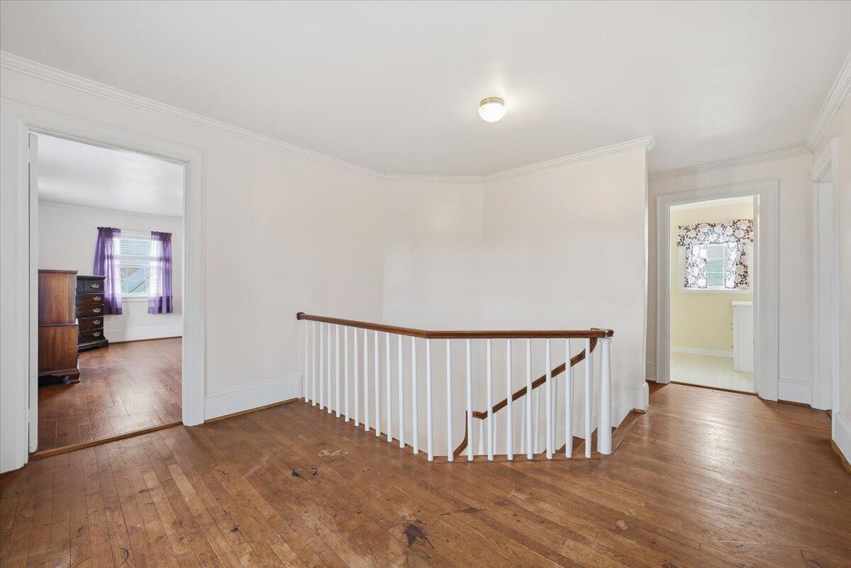 9419 Franklin Street Ferrum, VA 24088 - Photo 35 of 100 a view of a hallway with wooden floor and stairs