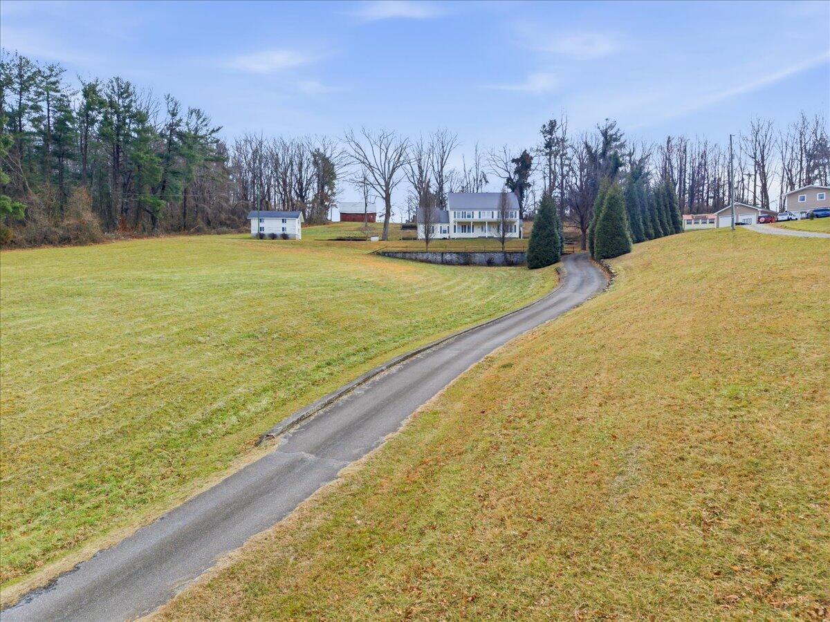 9419 Franklin Street Ferrum, VA 24088 - Photo 61 of 100 a view of a yard with swimming pool and trees in the background