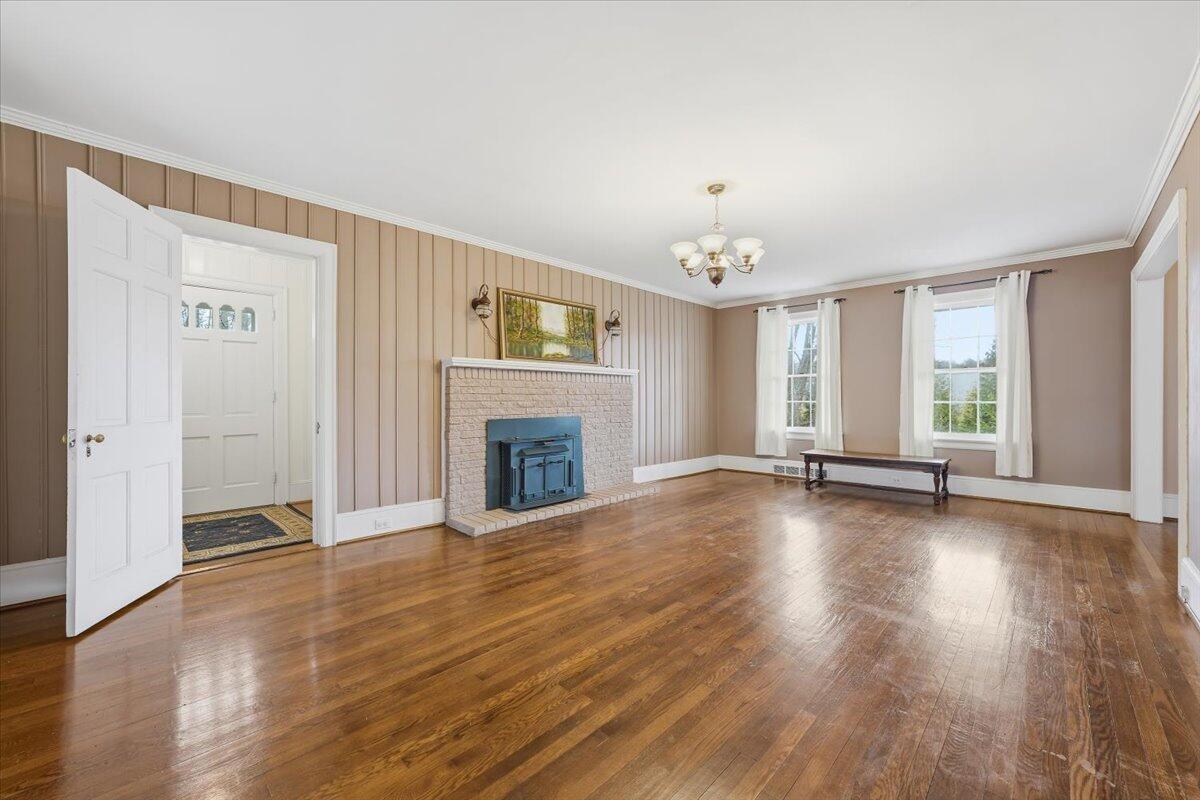 9419 Franklin Street Ferrum, VA 24088 - Photo 7 of 100 wooden floor fireplace and windows in an empty room
