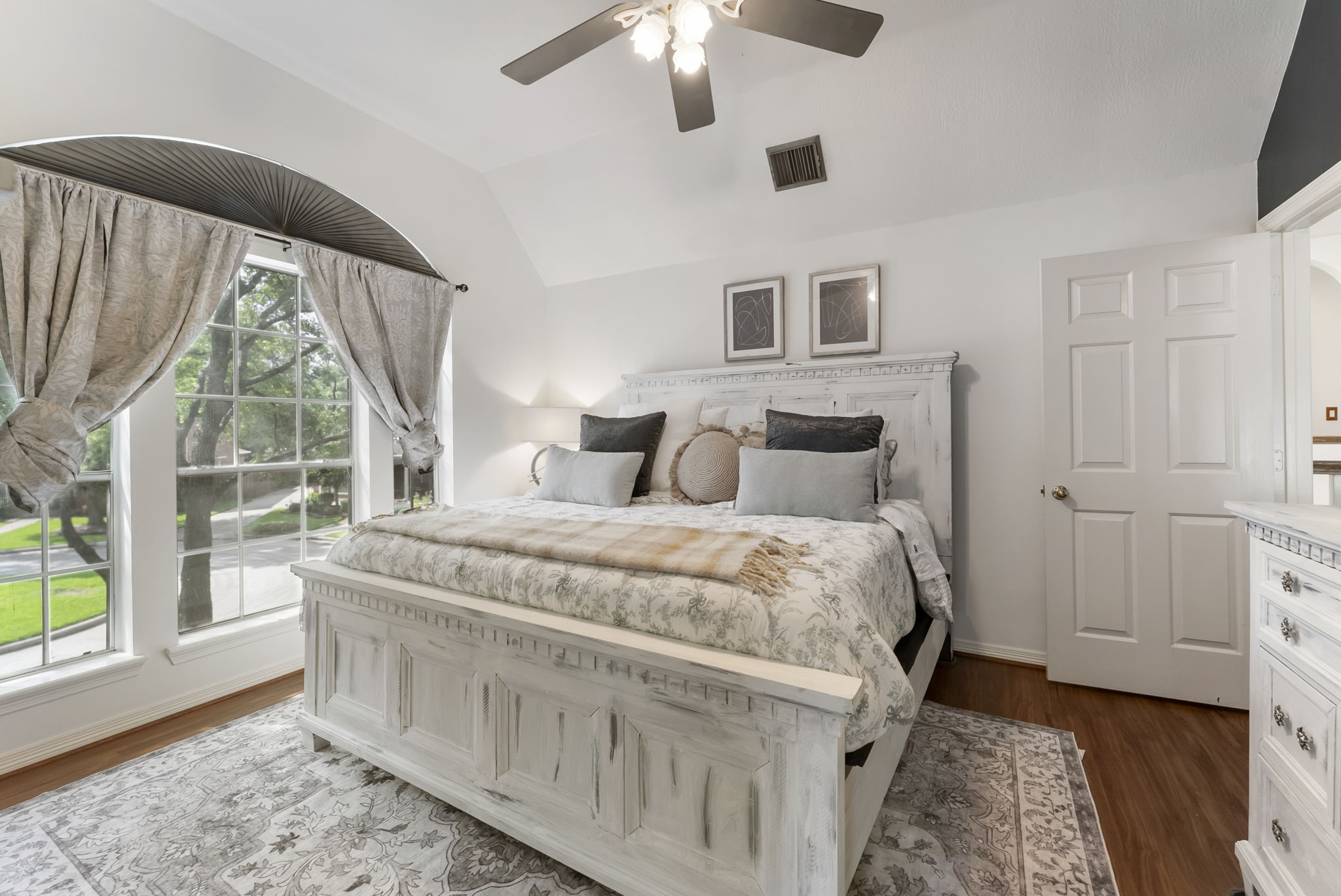 12907 Ryaneagles Circle Houston, TX 77044 - Photo 33 of 48 a bedroom with a large bed and a chandelier