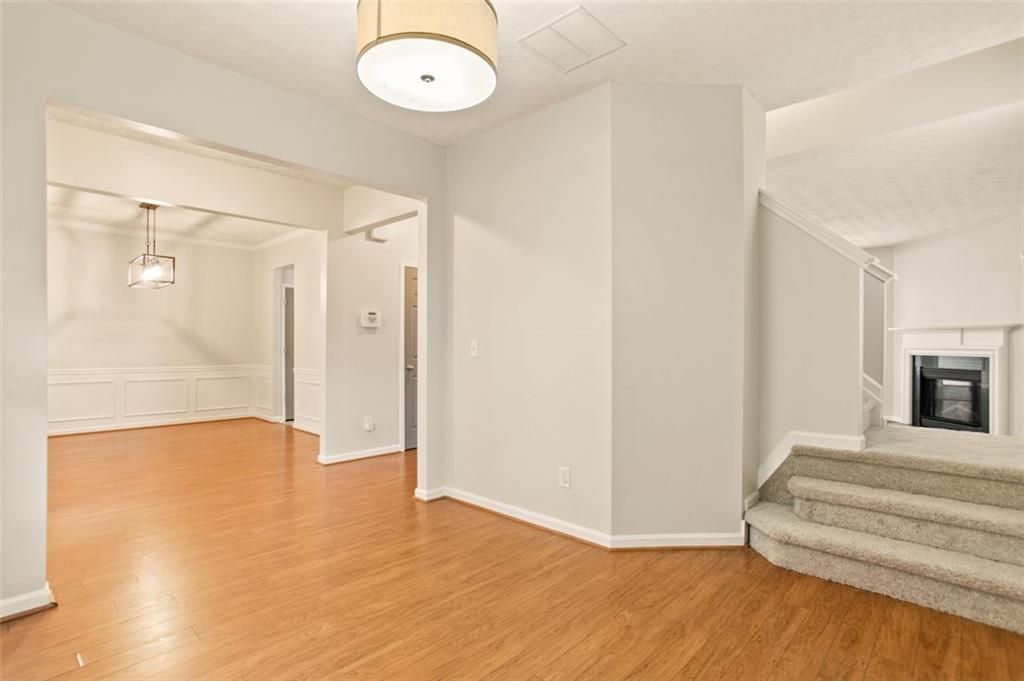808 Inkberry Road Canton, GA 30114 - Photo 12 of 50 a view of an empty room with wooden floor and a bathroom