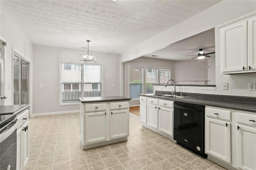 808 Inkberry Road Canton, GA 30114 - Photo 15 of 50 a large kitchen with cabinets and wooden floor