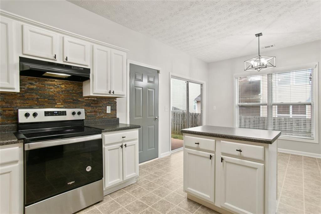 808 Inkberry Road Canton, GA 30114 - Photo 16 of 50 a kitchen with cabinets stainless steel appliances and wooden floor