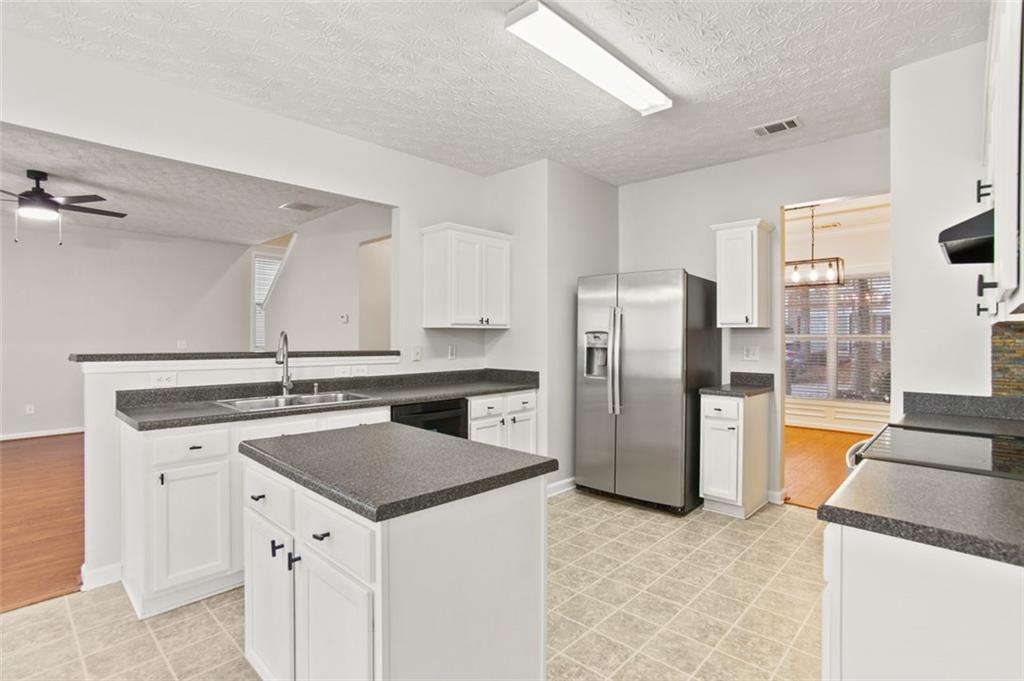 808 Inkberry Road Canton, GA 30114 - Photo 18 of 50 a kitchen with a stove a refrigerator and a sink