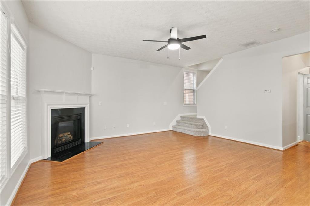 808 Inkberry Road Canton, GA 30114 - Photo 21 of 50 a view of empty room with fireplace and fan
