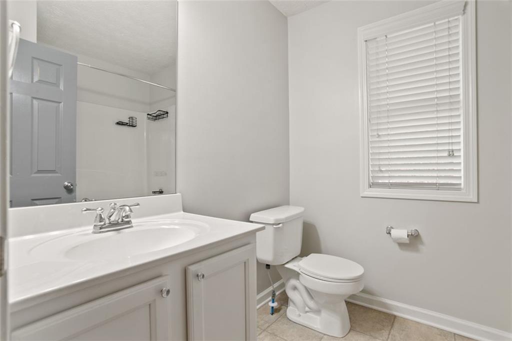808 Inkberry Road Canton, GA 30114 - Photo 27 of 50 a bathroom with a sink a toilet and a mirror