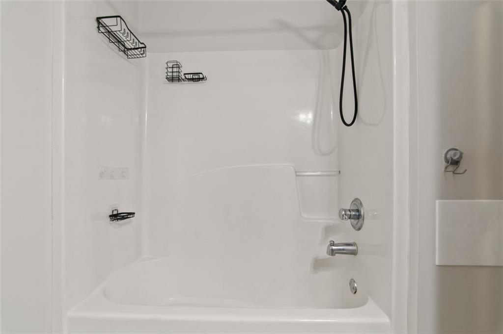 808 Inkberry Road Canton, GA 30114 - Photo 28 of 50 a bathroom with a bath tub with a shower
