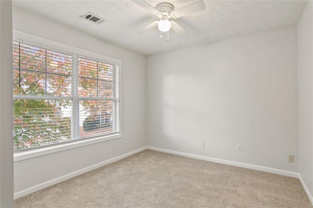 808 Inkberry Road Canton, GA 30114 - Photo 29 of 50 an empty room with a window and a fan