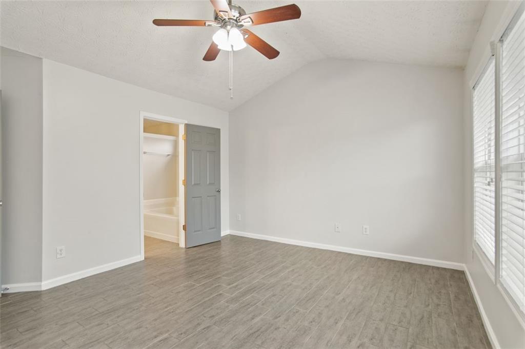 808 Inkberry Road Canton, GA 30114 - Photo 32 of 50 an empty room with wooden floor fan and windows