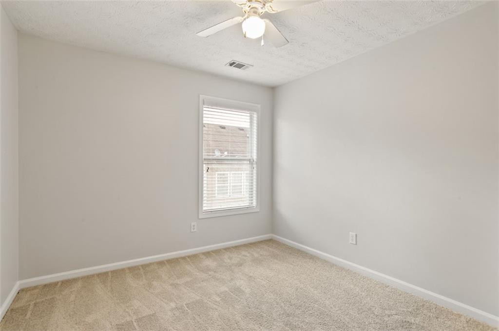 808 Inkberry Road Canton, GA 30114 - Photo 35 of 50 an empty room with a window and a fan