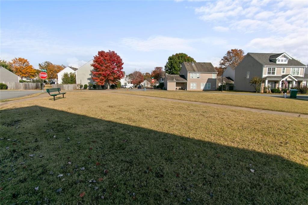 808 Inkberry Road Canton, GA 30114 - Photo 46 of 50 a front view of house with yard and trees in the background