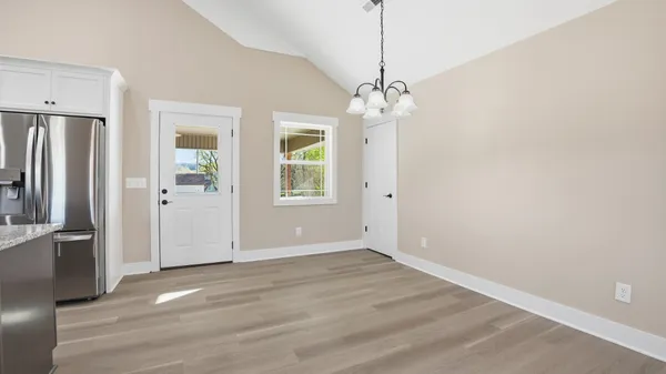 a kitchen with stainless steel appliances granite countertop a refrigerator stove top oven and sink