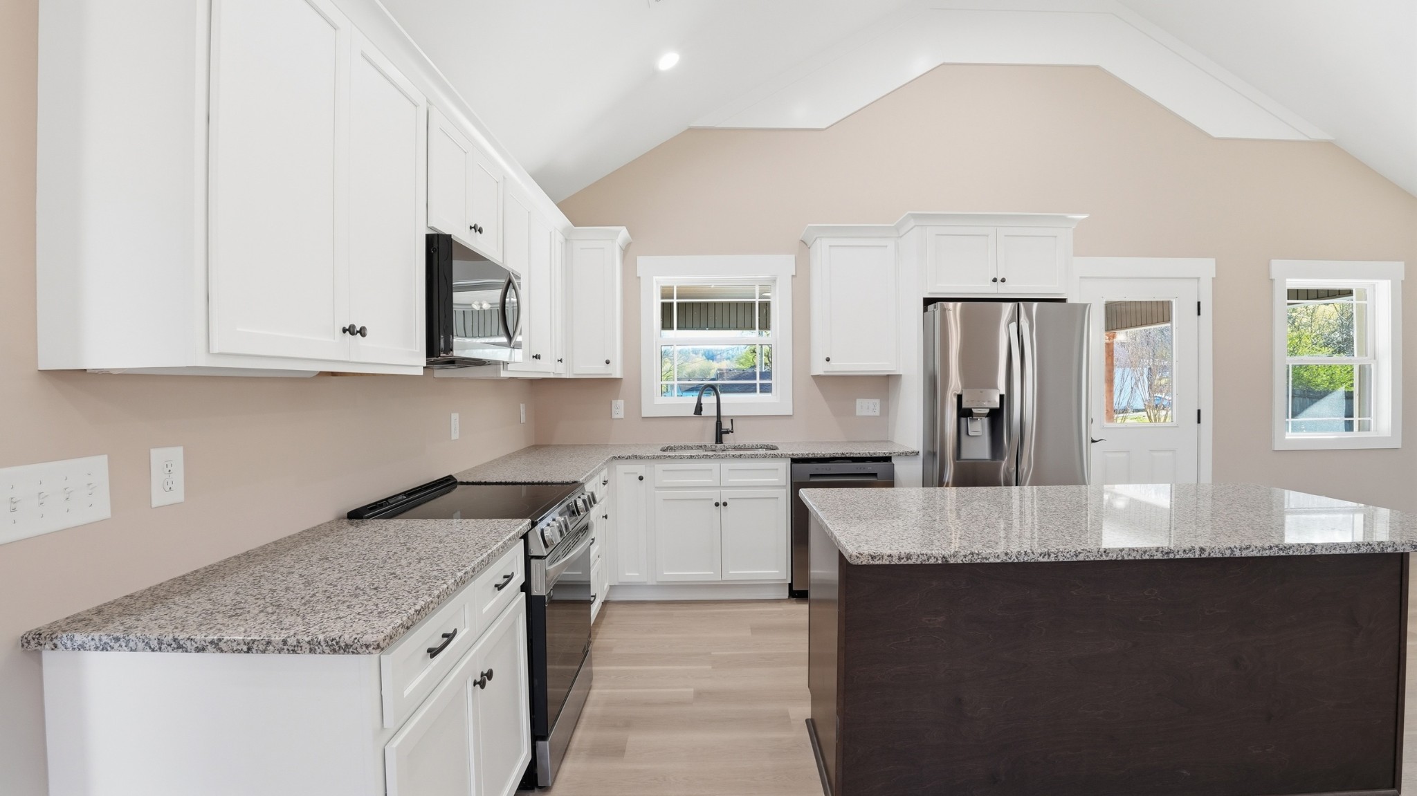 104 Division Street Normandy, TN 37360 - Photo 13 of 48 a kitchen with stainless steel appliances granite countertop a stove a sink dishwasher and a refrigerator with wooden floor