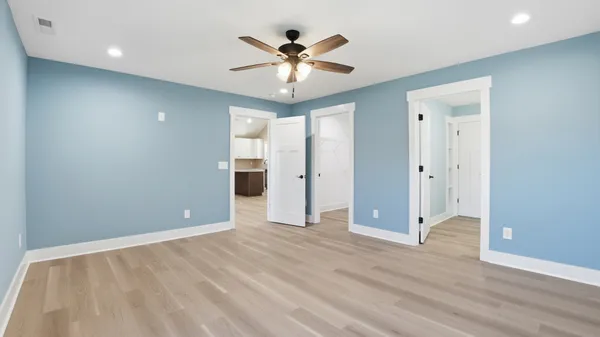 an empty room with windows and closet