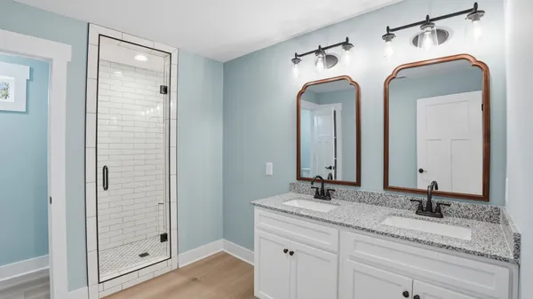 a bathroom with a glass shower door
