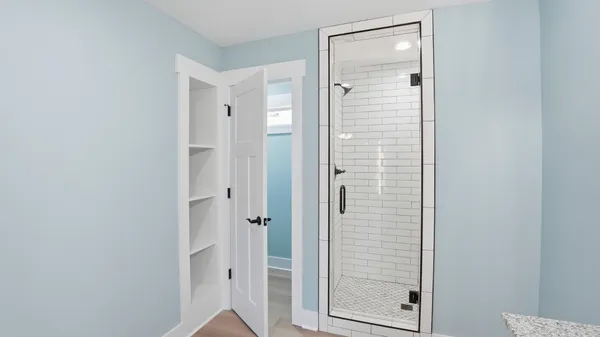 an empty room with a window and a ceiling fan