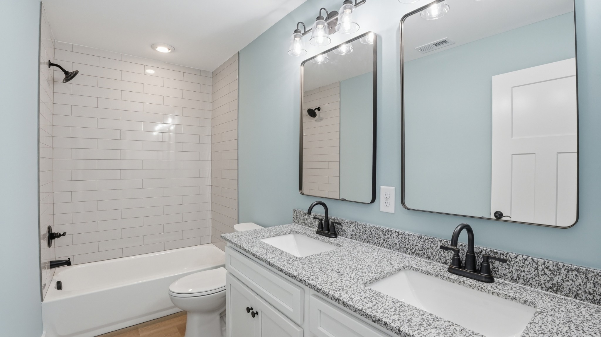 104 Division Street Normandy, TN 37360 - Photo 24 of 48 a bathroom with a granite countertop sink a mirror a bathtub and shower