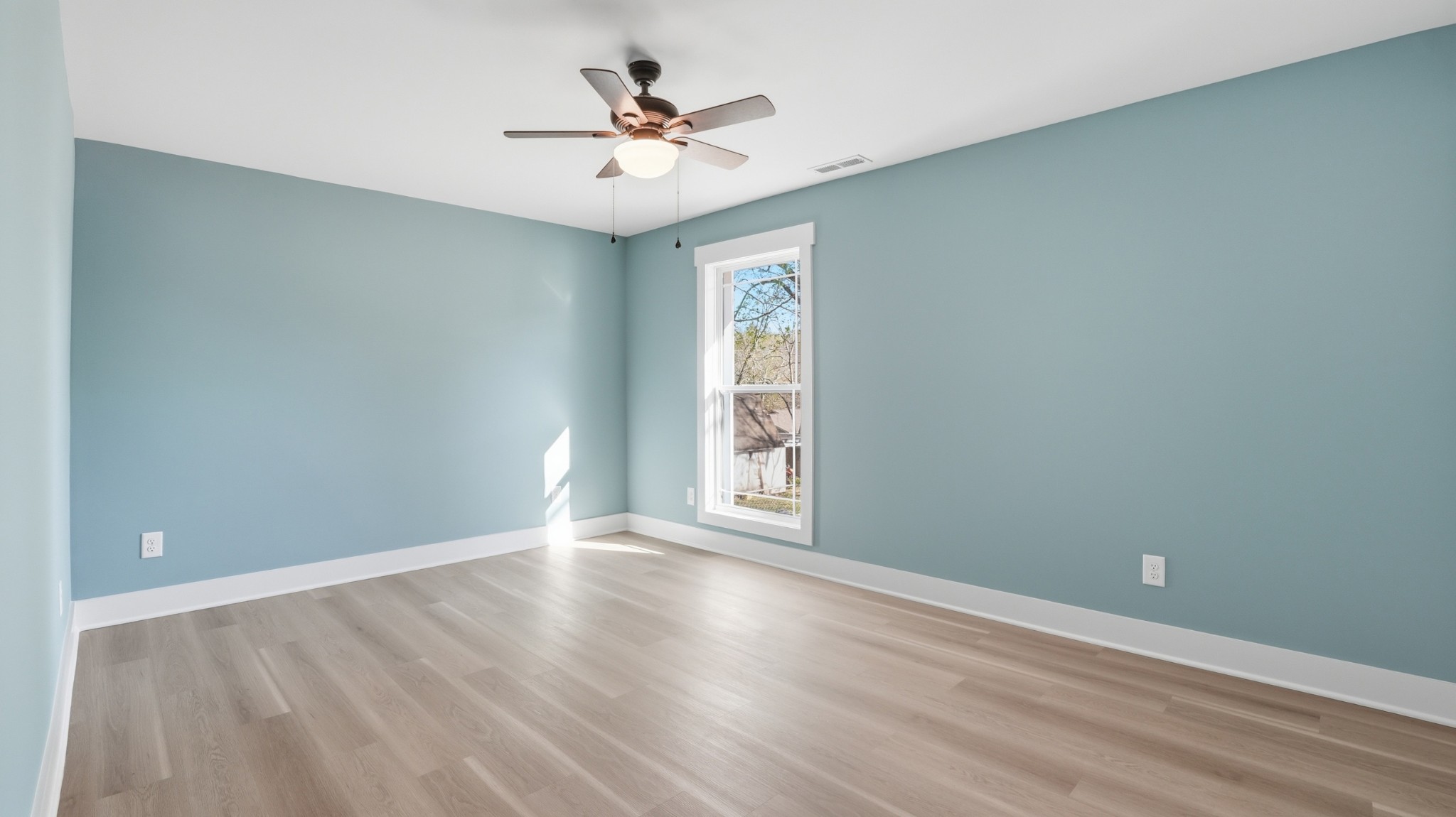 104 Division Street Normandy, TN 37360 - Photo 25 of 48 an empty room with wooden floor and windows