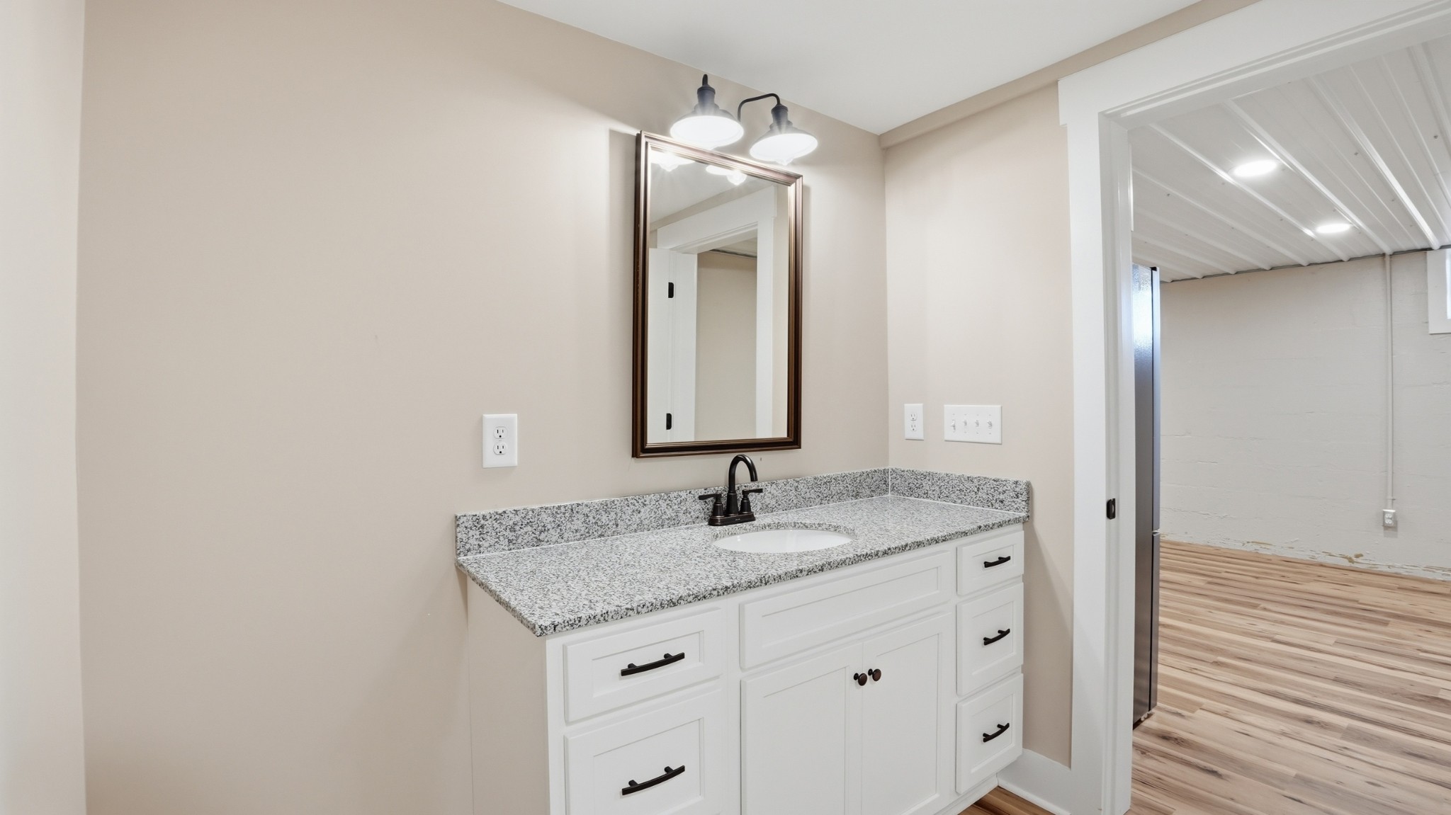104 Division Street Normandy, TN 37360 - Photo 33 of 48 a bathroom with a granite countertop sink and a mirror