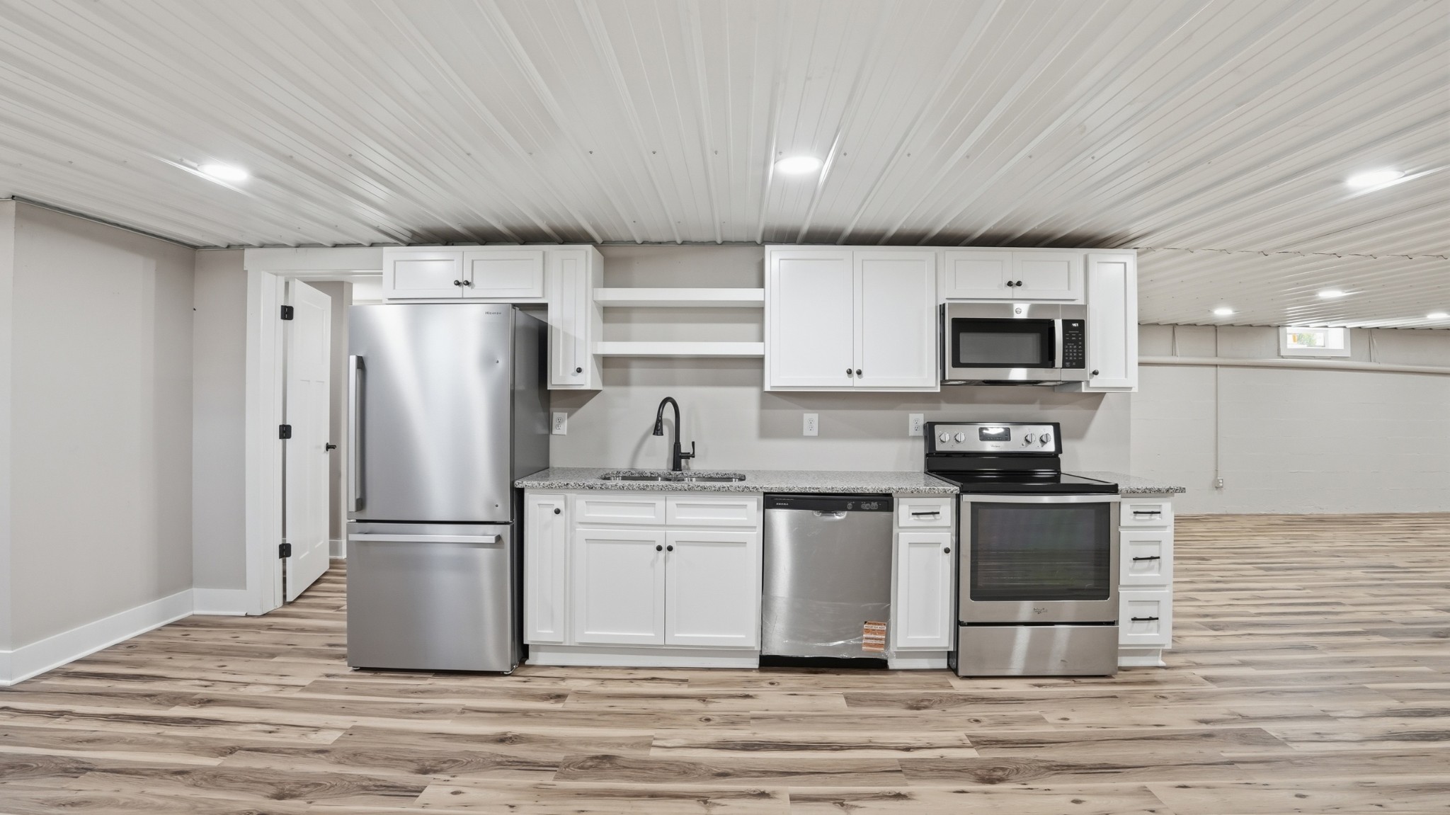 104 Division Street Normandy, TN 37360 - Photo 34 of 48 a kitchen with stainless steel appliances a refrigerator stove microwave and sink