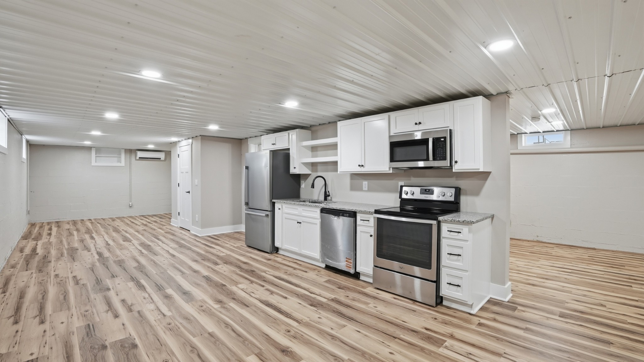 104 Division Street Normandy, TN 37360 - Photo 35 of 48 a kitchen with stainless steel appliances granite countertop a stove a sink and a refrigerator