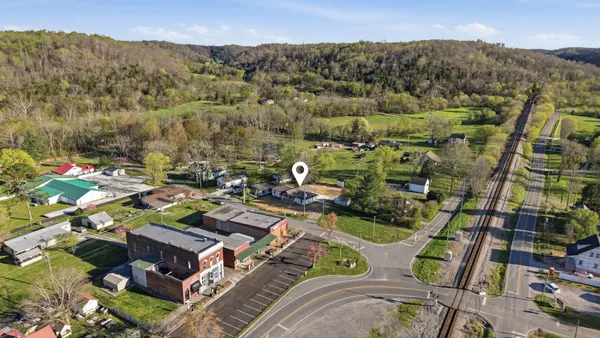 an aerial view of a residential houses with outdoor space