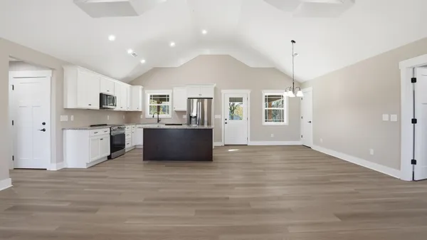a view of kitchen with sink microwave and cabinets