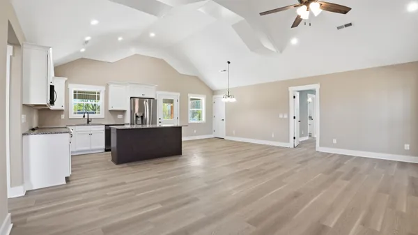 a large room with wooden floor and a chandelier