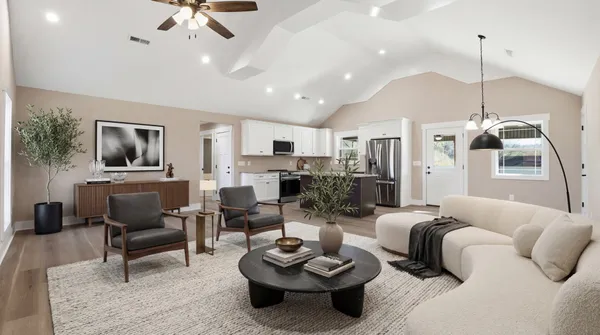 a view of empty room with wooden floor and window
