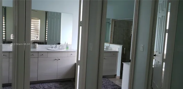 a bathroom with a double vanity sink and a mirror