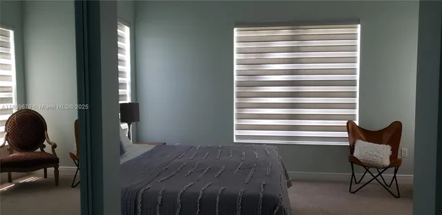 a bedroom with a bed and a chair