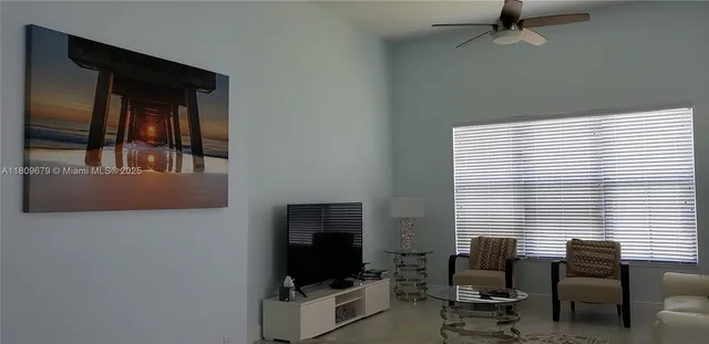 a view of a livingroom with workspace and a window