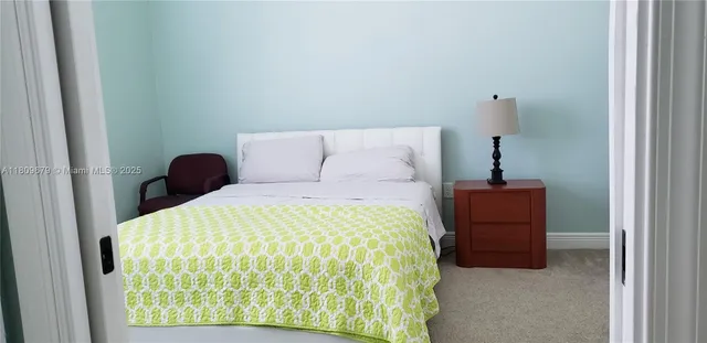 a bedroom with a bed and a mirror