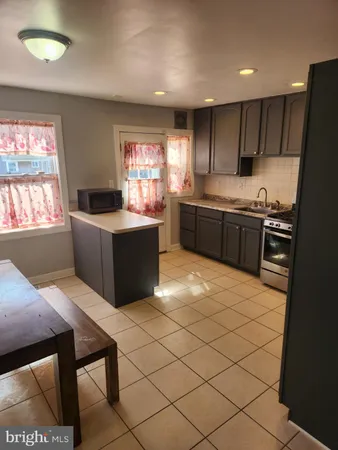 a kitchen with stainless steel appliances kitchen island granite countertop a sink counter space and cabinets