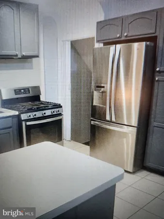 a kitchen with stainless steel appliances a refrigerator and a stove