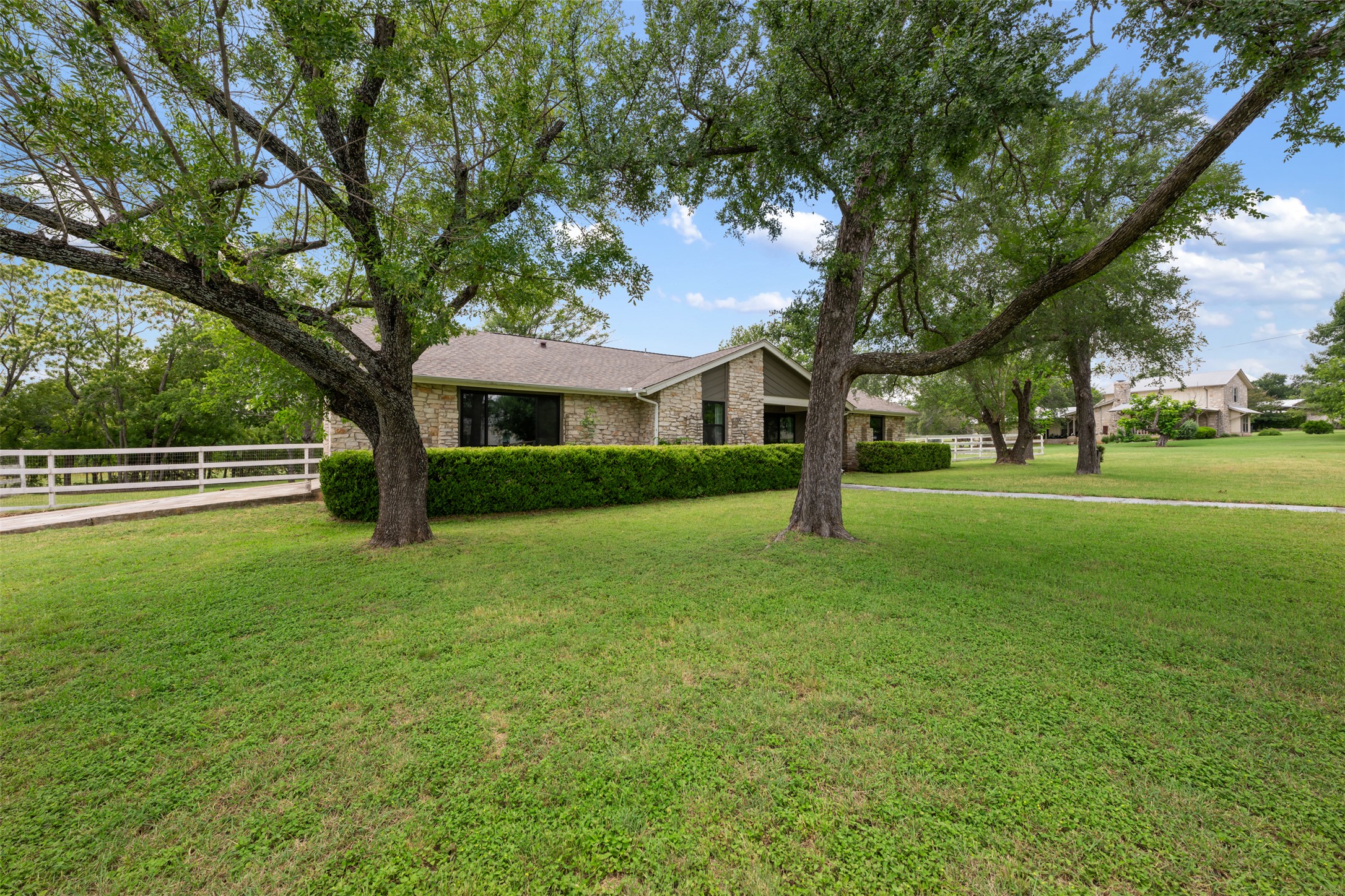 1600 Pin Oak Lane Round Rock, TX 78681 - Photo 2 of 40 Expansive front lawn with mature trees and a manicured hedge row