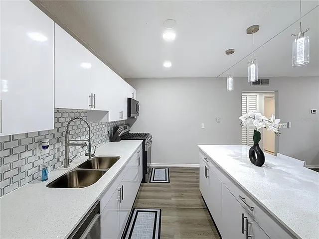 a bedroom with a large bed and a chandelier